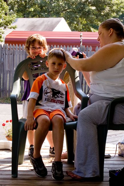 Getting a haircut
John, James and Mom on the front porch
