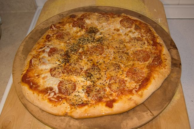Pizza pie
We finally managed to make a decent pie.  Asiago cheese and fresh mozzarella. Crushed red pepper and basil.  
